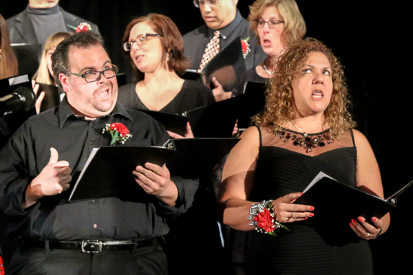 A Group of Adults in Black Singing Choirs