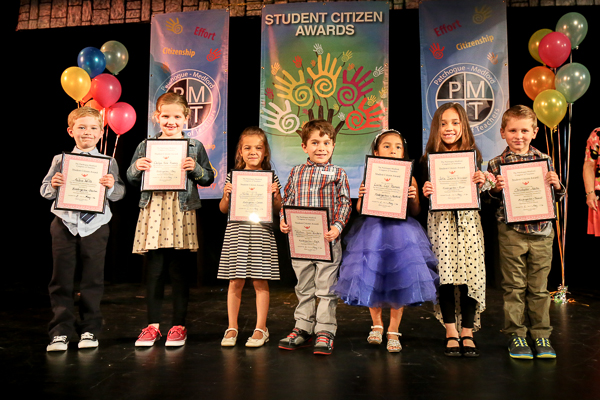 A Group of Children on Stage Holding Awards