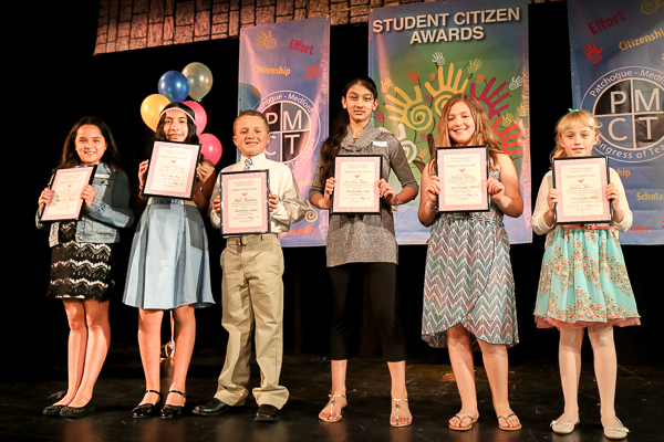 A Group of Children Holding Awards on Stage Twenty Two