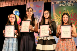 A Group of Children Holding Awards on Stage Twenty Five