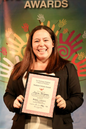 A Smiling Girl in Black Coat Holding an Award