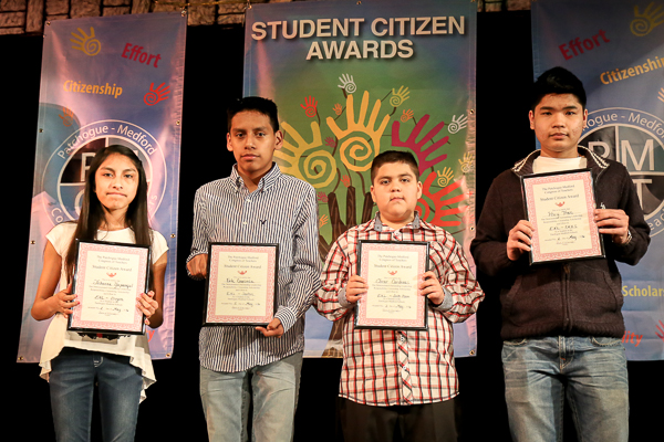A Group of Children Holding Awards on Stage Twenty Five