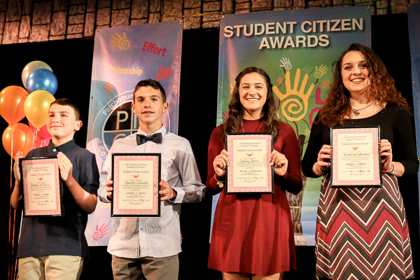 A Group of Children Holding Awards on Stage Twenty Seven