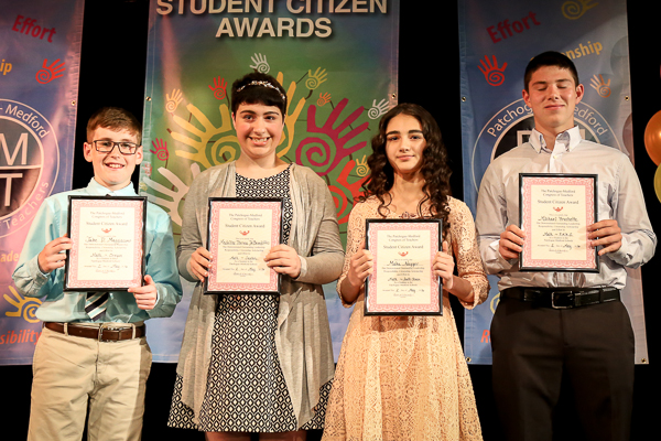 A Group of Students Holding Awards on Stage Thirty